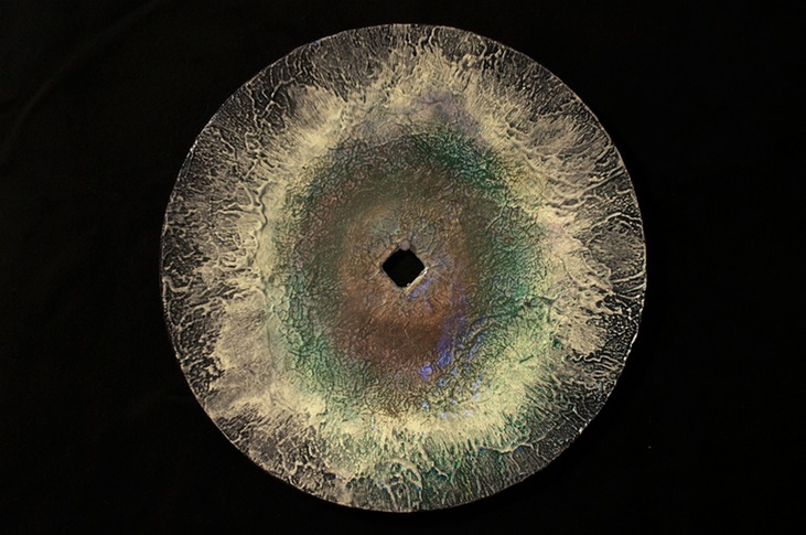 Drew Wood, Insomnia 4, 2007, phosphorus, color-shifting enamel, acrylic, garnet, and synthetic resin on a found concave iron plow disc from a Missouri farm, 8" radius